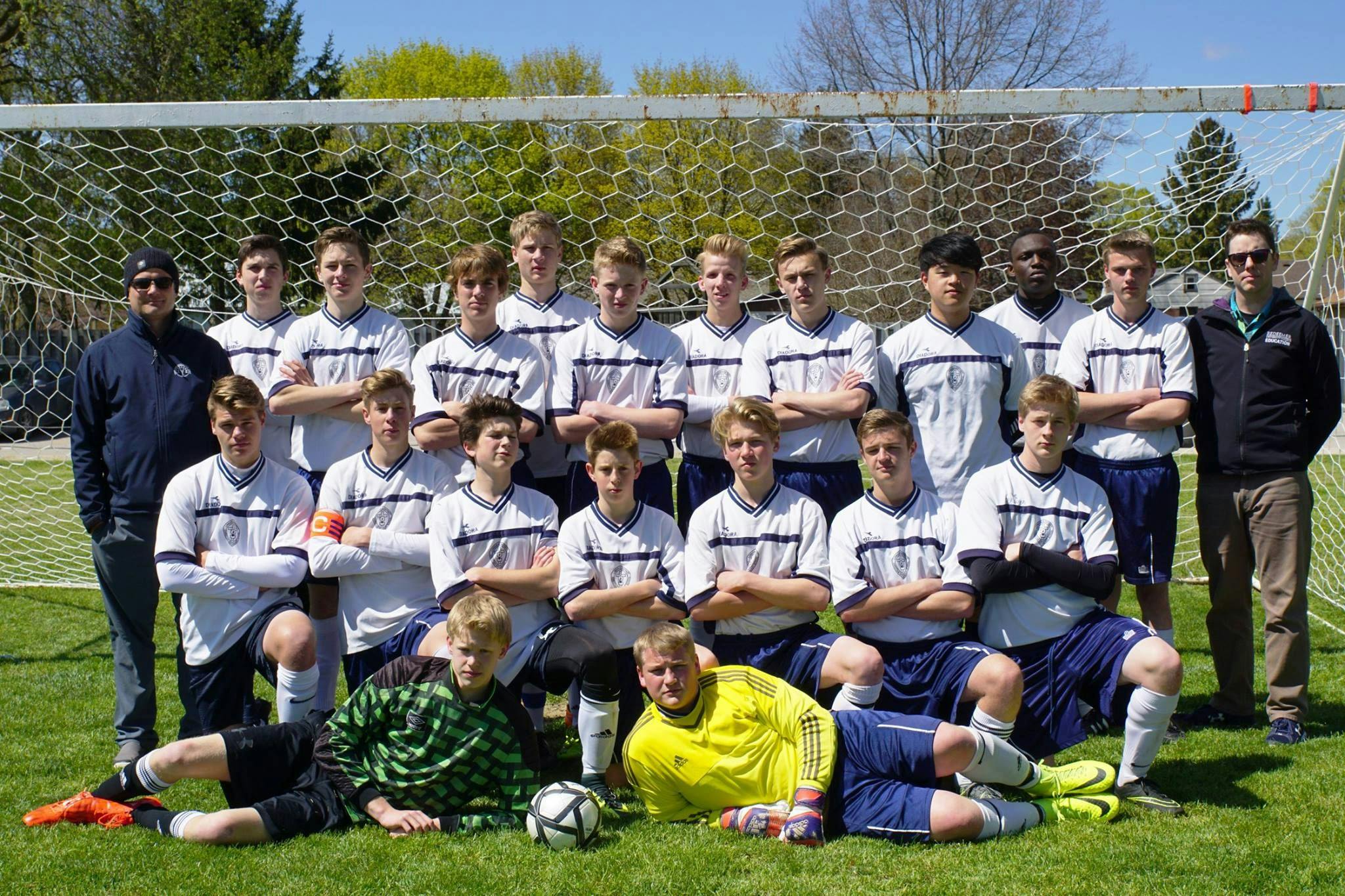 London Christian High boys soccer team posing for a team picture in front of a soccer goal.